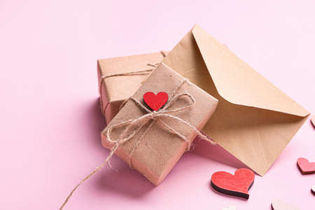 Gift boxes for Valentine's Day, envelope and red hearts on color backgroundの写真素材