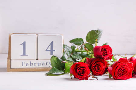 Calendar and rose flowers on table. Valentine's day celebrationの写真素材
