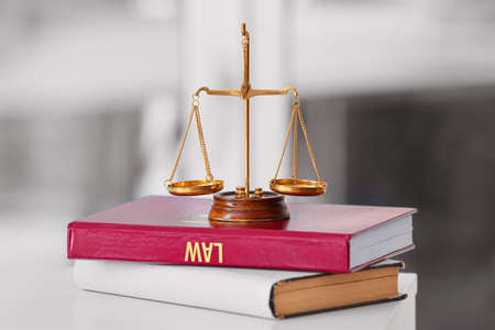 Scales of justice with books on lawyer's workplace