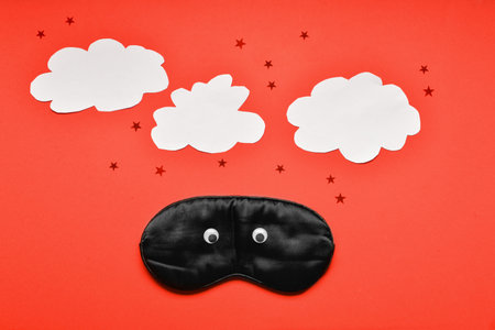 Funny composition with sleep mask on color backgroundの写真素材