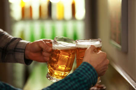 Friends drinking fresh beer in pub