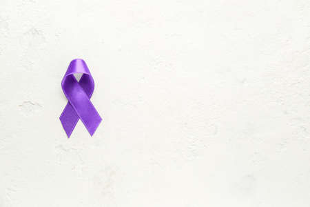 Purple ribbon as symbol of World Cancer Day on light backgroundの写真素材