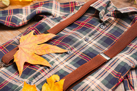Stylish autumn kid clothes with leaves on table, closeupの写真素材