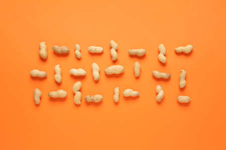 Tasty peanuts on color backgroundの写真素材