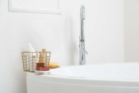 Body care cosmetics with accessories on bathtub