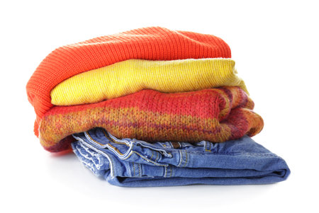 Stack of clean clothes on white backgroundの写真素材