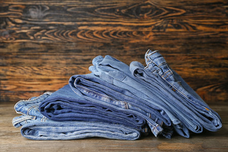 Stack of clean clothes on wooden tableの写真素材