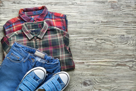 Clean kid clothes with shoes on tableの写真素材