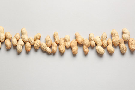 Tasty peanuts on light background