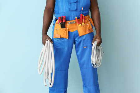 African-American electrician on color backgroundの写真素材