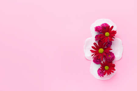 Menstrual pad with flowers on color background. Menstruation concept