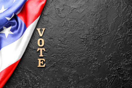 USA flag and text VOTE on dark background