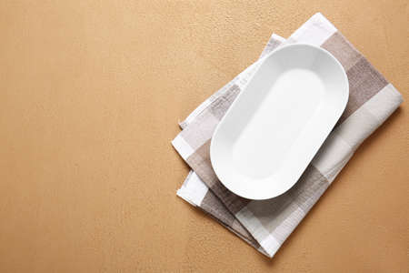 Empty plate and napkin on color backgroundの写真素材