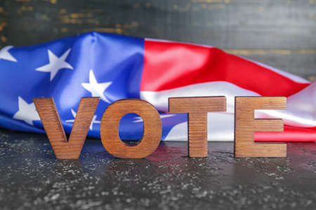 Text VOTE and USA flag on tableの写真素材