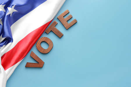 USA flag and text VOTE on color backgroundの写真素材