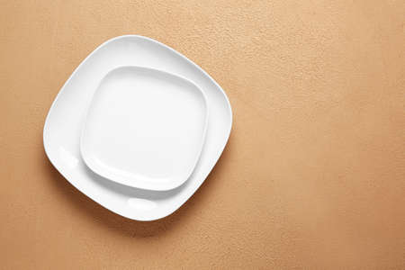 Empty plates on color backgroundの写真素材