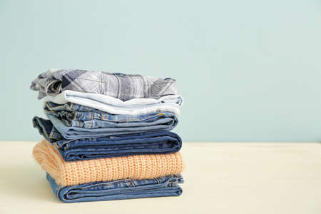 Stack of warm clothes on tableの写真素材