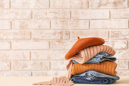 Stack of warm clothes on tableの写真素材
