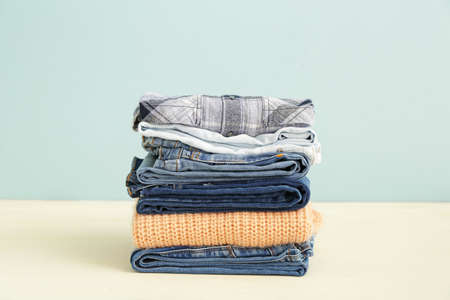 Stack of warm clothes on tableの写真素材