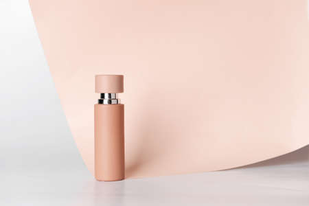 Bottle of perfume with paper sheet on white backgroundの写真素材