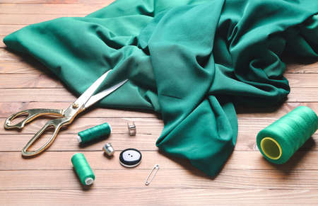 Set of tailor's supplies on wooden backgroundの写真素材