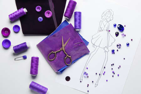 Set of tailor's supplies with sketch on white background