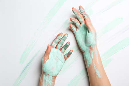 Artist's hands in paint on white backgroundの写真素材