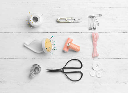 Set of tailor's supplies on wooden backgroundの写真素材