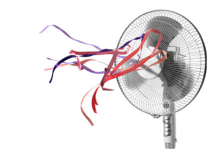 Electric fan with fluttering ribbons on white backgroundの写真素材