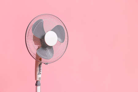 Electric fan on color backgroundの写真素材