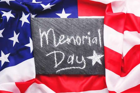 Board with text MEMORIAL DAY on USA flagの写真素材