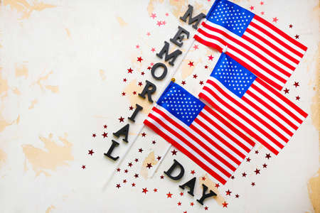 USA flags and text MEMORIAL DAY on light backgroundの写真素材