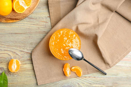 Composition with jar of sweet jam and tangerines on tableの写真素材