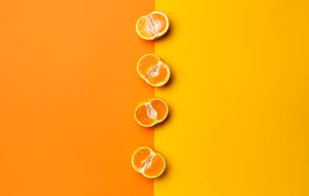Ripe tasty tangerines on color backgroundの写真素材
