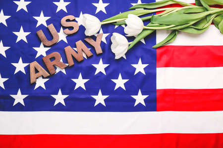 Text US ARMY and flowers on American flag. Memorial day celebrationの写真素材