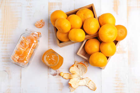 Composition with jar of sweet jam and tangerines on tableの写真素材