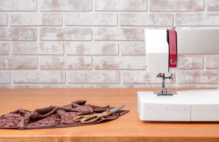 Sewing machine with supplies on tableの写真素材