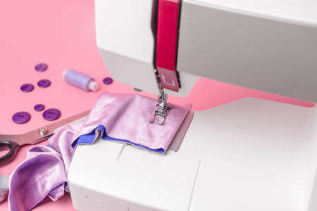 Sewing machine with supplies on color background, closeupの写真素材