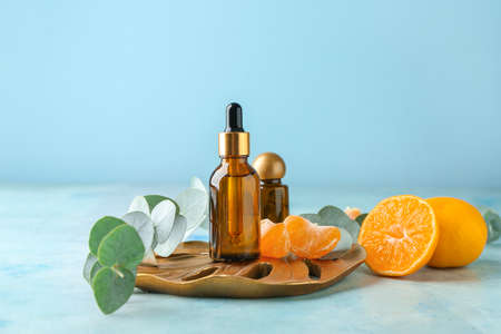 Bottles of tangerine essential oil on tableの写真素材