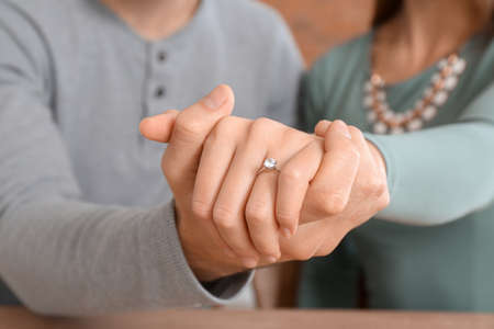 Hands of happy engaged young couple, closeupの写真素材