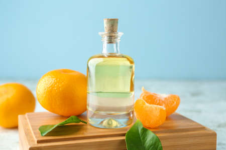 Bottle of tangerine essential oil on tableの写真素材