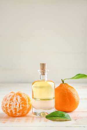 Bottle of tangerine essential oil on tableの写真素材