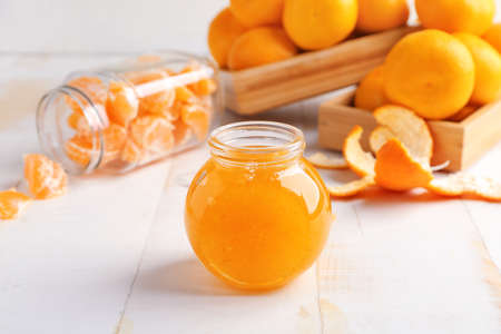 Jar of sweet tangerine jam on tableの写真素材
