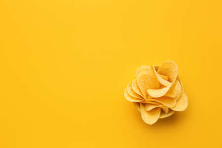 Bowl with tasty potato chips on color backgroundの写真素材
