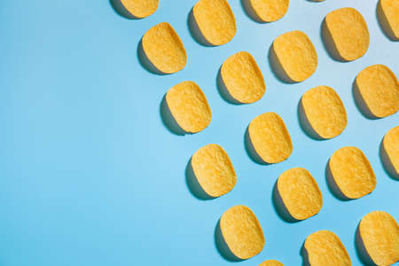 Tasty potato chips on color backgroundの写真素材