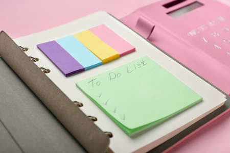 Notebook and blank to-do list on color background, closeup
