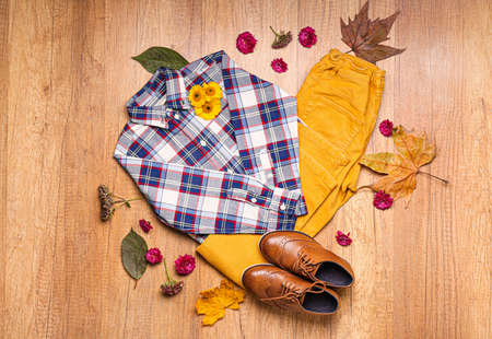 Stylish autumn kid clothes on wooden backgroundの写真素材