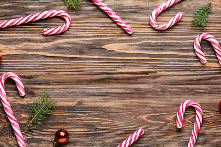 Beautiful Christmas composition with candy canes on wooden backgroundの写真素材