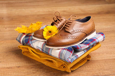 Stylish autumn kid clothes on wooden backgroundの写真素材