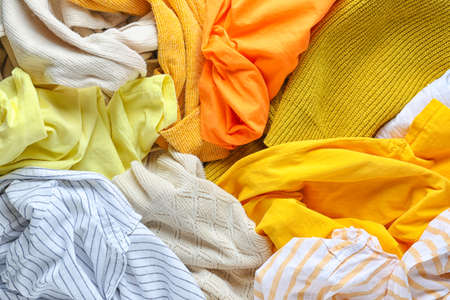 Heap of different clothes, top viewの写真素材
